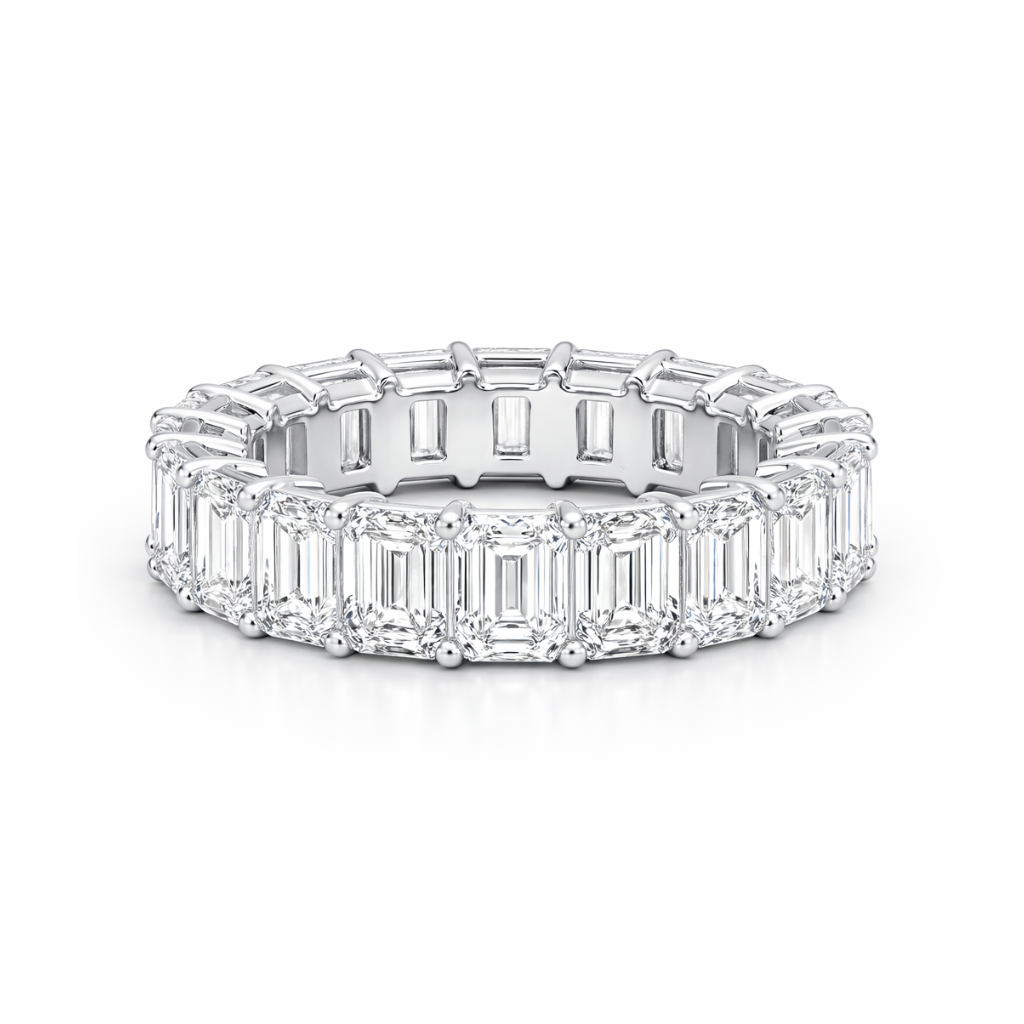 Diamond ring with emerald-cut stones on a white background