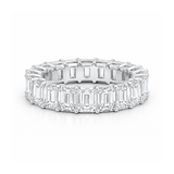 Diamond ring with emerald-cut stones on a white background